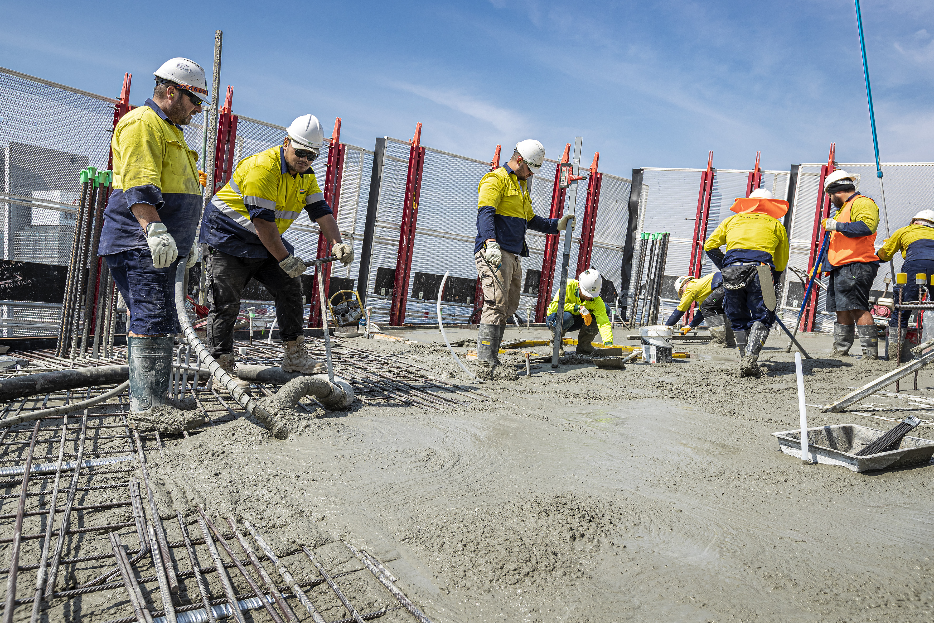 Concreters placing structural concrete on high-rise building