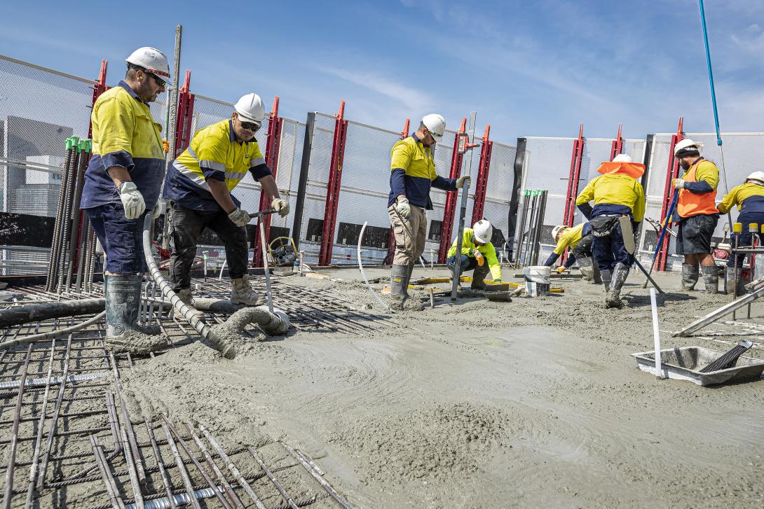 Concreters placing structural concrete on high-rise building