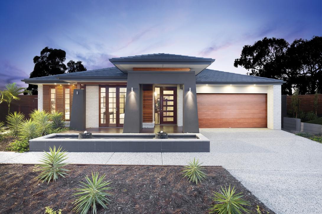 House with exposed concrete driveway and footpath