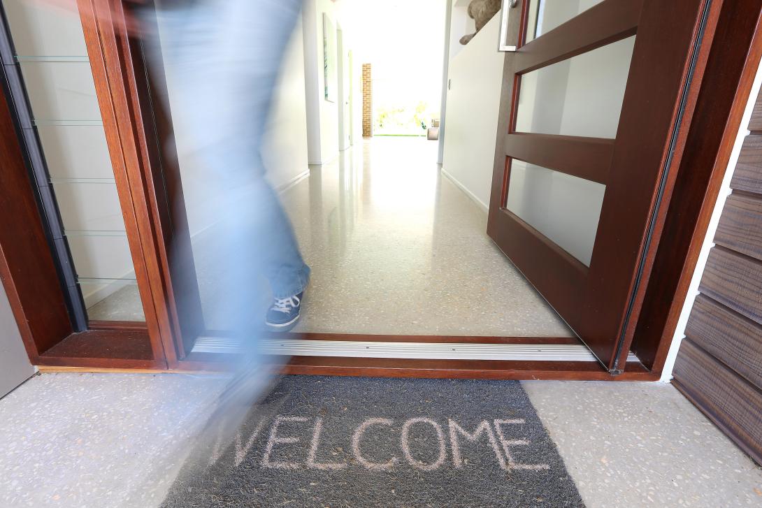 Q-stone polished concrete in house entry with welcome mat