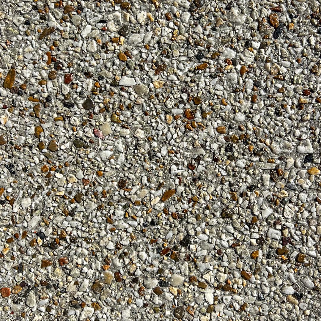 Close up swatch of concrete with exposed aggregates in the shade Arctic Sun