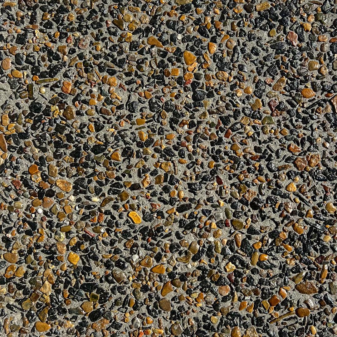 Close up swatch of concrete with exposed aggregates in the shade Bengal