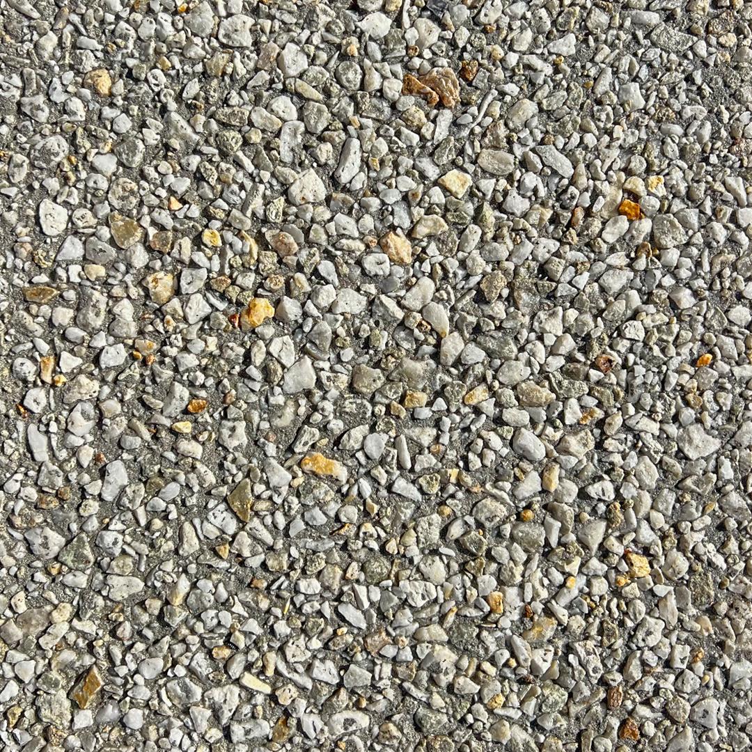 Close Up swatch of exposed aggregate concrete in the shade Pearl